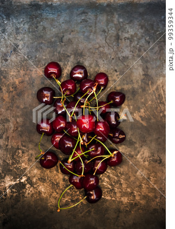 A bunch of fresh juicy cherries on a dark old background, toned 99359344