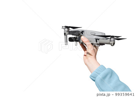 Hand holding drone ready to take off isolated on the whire background. Drone in hand Hand holding drone ready to take off isolated on the whire background. Drone in hand 99359641