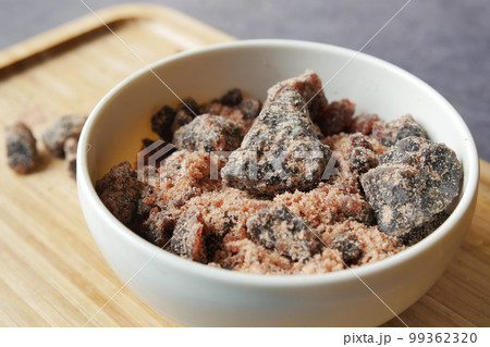 Himalayan black salt rock crystals, Kala Namak in a container on table  99362320