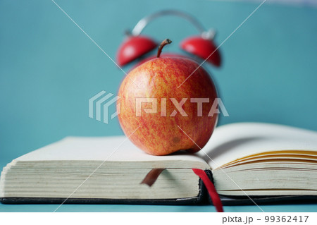 black to school concept with apple on notepad on table. black to school concept with apple on notepad on table. 99362417