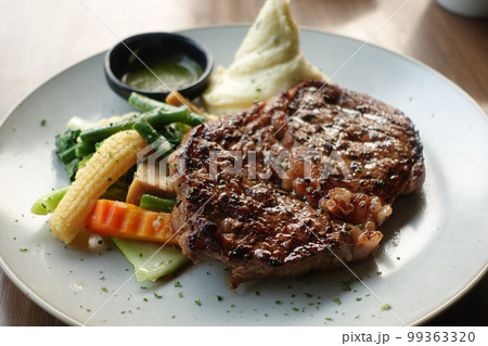 beef steaks meat with vegetables on a plate  99363320