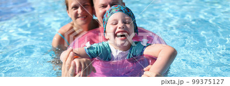Happy laughing joyful family couple and baby in pool 99375127