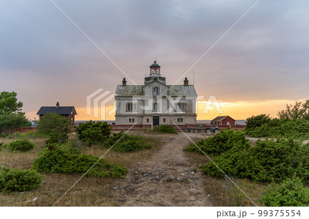 Stone lighthouse building in summer afternoon sun on Stora Karlso. Gotland, Sweden Stone lighthouse building in summer afternoon sun on Stora Karlso. Gotland, Sweden 99375554
