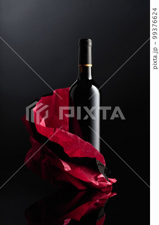 Bottle of red wine on a crumpled paper. Bottle of red wine on a crumpled paper. 99376624