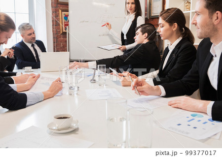 Business people at presentation in office 99377017
