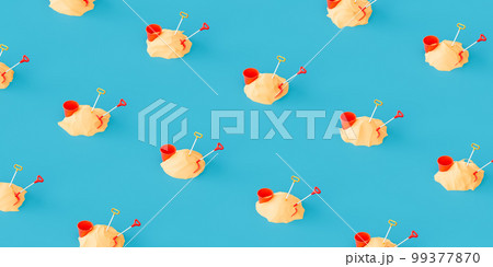 Pattern with bucket and shovel in sand against blue background Pattern with bucket and shovel in sand against blue background 99377870
