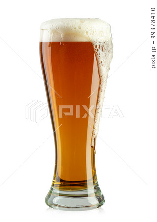Glass of beer on white background. The foam of the drink pours over the glass. 99378410