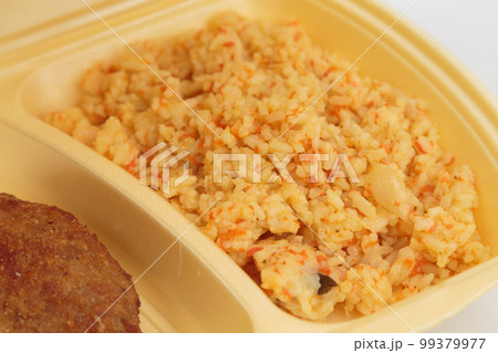 Cutlet and rice in a plastic box for delivery. 99379977