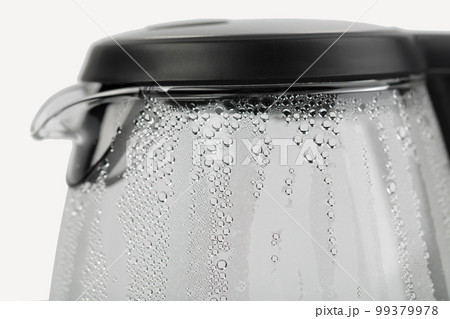 Electric glass teapot with water drops. Electric glass teapot with water drops. 99379978