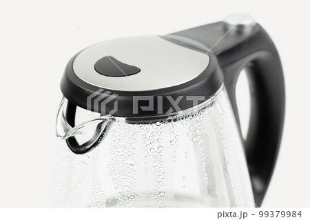 Electric glass teapot with water drops. 99379984