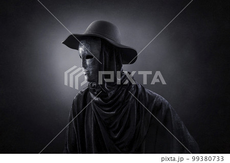 Creepy figure with old hat over dark misty background Creepy figure with old hat over dark misty background 99380733