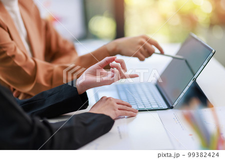 Concept of business investment or working woman, Closeup businesswoman discussing or working on analysis of business investment documents and using computer tablet to analytic business data. Concept of business investment or working woman, Closeup businesswoman discussing or working on analysis of business investment documents and using computer tablet to analytic business data. 99382424