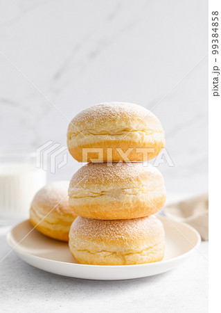 Berliner donut. Traditional german donut with raspberry jam, dusted with icing sugar Berliner donut. Traditional german donut with raspberry jam, dusted with icing sugar 99384858