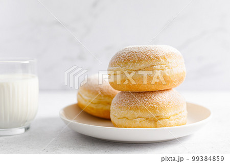 Berliner donut. Traditional german donut with raspberry jam, dusted with icing sugar Berliner donut. Traditional german donut with raspberry jam, dusted with icing sugar 99384859