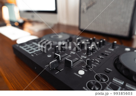 dj controller,DJ Spinning, Mixing, and Scratching in house dj controller,DJ Spinning, Mixing, and Scratching in house 99385603