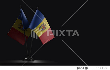 Small national flags of the Moldavia on a black background 99387409