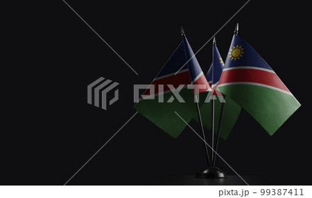 Small national flags of the Namibia on a black background 99387411