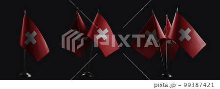 Small national flags of the Switzerland on a black background 99387421