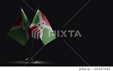 Small national flags of the Burundi on a black background 99387499