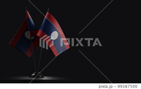Small national flags of the Laos on a black background 99387500