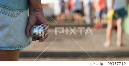 Senior playing petanque un and relaxing game. Senior woman prepared to throw the boules ball in a park in outdoor play 99387710
