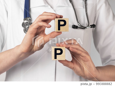 PP vitamin, word acronym on cubes in hands PP vitamin, word acronym on cubes in hands 99388882
