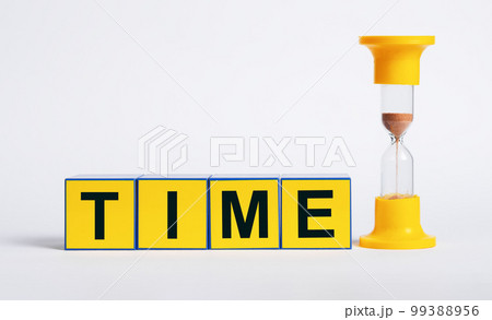 Hourglass and cubes with word time. Sand clock measuring one minute passage. Deadline and punctuality concept 99388956