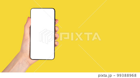 Banner with hand holding phone mockup on yellow background. Smartphone template. Copy space Banner with hand holding phone mockup on yellow background. Smartphone template. Copy space 99388968