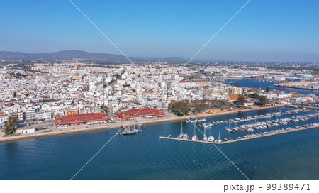 Aerial view of the Portuguese fishing tourist town of Olhao overlooking the Ria Formosa Marine Park. sea port for yachts and Municipal market Aerial view of the Portuguese fishing tourist town of Olhao overlooking the Ria Formosa Marine Park. sea port for yachts and Municipal market 99389471