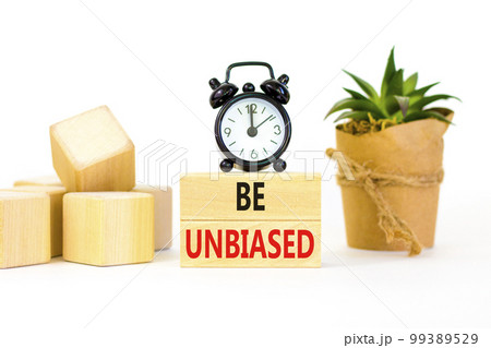 Be unbiased symbol. Concept words Be unbiased on wooden block. Beautiful white table white background. Black alarm clock. Green house plant. Business psychology be unbiased concept. Copy space. Be unbiased symbol. Concept words Be unbiased on wooden block. Beautiful white table white background. Black alarm clock. Green house plant. Business psychology be unbiased concept. Copy space. 99389529
