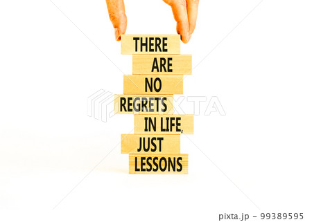 Regrets or lessons symbol. Concept words There are no regrets in life just lessons on wooden blocks on a beautiful white background. Businessman hand. Business regrets or lessons concept. Copy space Regrets or lessons symbol. Concept words There are no regrets in life just lessons on wooden blocks on a beautiful white background. Businessman hand. Business regrets or lessons concept. Copy space 99389595