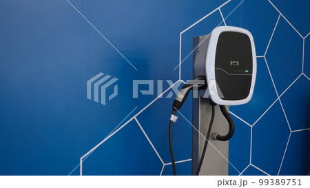 EV Charger quick charge type at car parking which DC Charging faster than AC system. EV Charger car station charging use AC socket plug for electric engine vehicle. Future transport energy technology 99389751