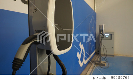 EV Charger quick charge type at car parking which DC Charging faster than AC system. EV Charger car station charging use AC socket plug for electric engine vehicle. Future transport energy technology EV Charger quick charge type at car parking which DC Charging faster than AC system. EV Charger car station charging use AC socket plug for electric engine vehicle. Future transport energy technology 99389762