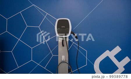 EV Charger quick charge type at car parking which DC Charging faster than AC system. EV Charger car station charging use AC socket plug for electric engine vehicle. Future transport energy technology EV Charger quick charge type at car parking which DC Charging faster than AC system. EV Charger car station charging use AC socket plug for electric engine vehicle. Future transport energy technology 99389778