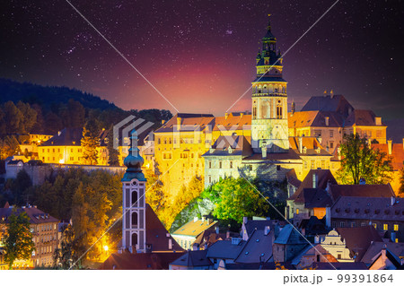 Cesky Krumlov, Czech Republic. Amazing Bright Starry Sky Castle Tower And Old Town Cityscape Skyline. Famous Landmark In Autumn Evening Night Scenic View. Unesco World Heritage Site 99391864