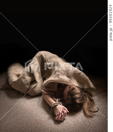 The bound prisoner lies on the floor The bound prisoner lies on the floor 99391924