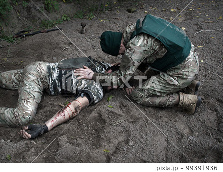 The friend cries at wounded soldier The friend cries at wounded soldier 99391936