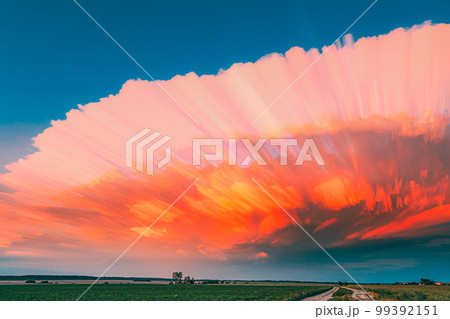 Long Exposure Fasters Clouds Above Countryside Rural Field Landscape. Amazing Effects Of Smeared Clouds. Of Moving Clouds Trails Sky. Sunlight Shining Through Clouds. Sunrays, Sunray, Ray, Dramatic Long Exposure Fasters Clouds Above Countryside Rural Field Landscape. Amazing Effects Of Smeared Clouds. Of Moving Clouds Trails Sky. Sunlight Shining Through Clouds. Sunrays, Sunray, Ray, Dramatic 99392151