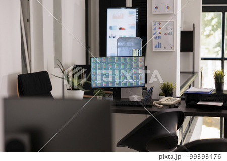 Company of investment experts running stock market software on desktop computer in office with no staff working in it. Early morning work place before employees arrive. Company of investment experts running stock market software on desktop computer in office with no staff working in it. Early morning work place before employees arrive. 99393476