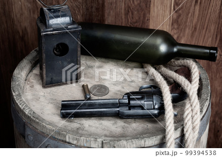 Old west revolver with cartridge and silver dollar Old west revolver with cartridge and silver dollar 99394538