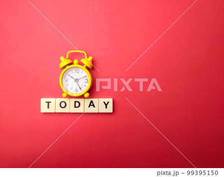 Yellow alarm clock with the word TODAY on a red background. 99395150
