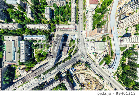 Aerial city view with crossroads and roads, houses, buildings, parks and parking lots. Sunny summer panoramic image Aerial city view with crossroads and roads, houses, buildings, parks and parking lots. Sunny summer panoramic image 99401315