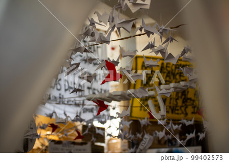 Japanese folded Origami cranes hanging on with strings. Hundreds handmade paper birds isolated with copy space. 1000 thousand crane sculpture topic. Symbol of peace, faith, health, wishes, hope Japanese folded Origami cranes hanging on with strings. Hundreds handmade paper birds isolated with copy space. 1000 thousand crane sculpture topic. Symbol of peace, faith, health, wishes, hope 99402573