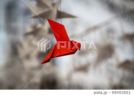 Japanese folded Origami cranes hanging on with strings. Hundreds handmade paper birds isolated with copy space. 1000 thousand crane sculpture topic. Symbol of peace, faith, health, wishes, hope 99402601