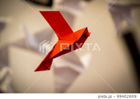 Japanese folded Origami cranes hanging on with strings. Hundreds handmade paper birds isolated with copy space. 1000 thousand crane sculpture topic. Symbol of peace, faith, health, wishes, hope Japanese folded Origami cranes hanging on with strings. Hundreds handmade paper birds isolated with copy space. 1000 thousand crane sculpture topic. Symbol of peace, faith, health, wishes, hope 99402609