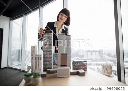 Confident businesswoman real estate agents ecologist in black stylish formal suit Confident businesswoman real estate agents ecologist in black stylish formal suit 99406096