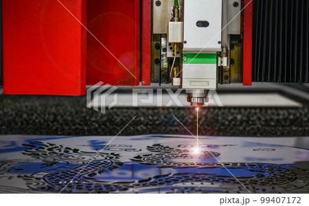 Industrial laser cut machine while cutting the sheet metal with the sparking light. Industrial laser cut machine while cutting the sheet metal with the sparking light. 99407172