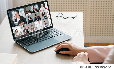 Video chat. Virtual meeting. Internet conference. Business colleagues brainstorming working online on laptop screen at office workplace. 99409272