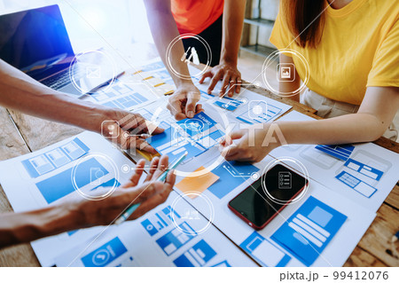 UX developer and ui designer brainstorming about mobile app interface wireframe design with customer breif and color code at modern office.. 99412076