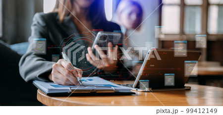 Businessman hand Project manager working and update tasks and Gantt chart scheduling virtual diagram.with smart phone, tablet and laptop in office.. Businessman hand Project manager working and update tasks and Gantt chart scheduling virtual diagram.with smart phone, tablet and laptop in office.. 99412149